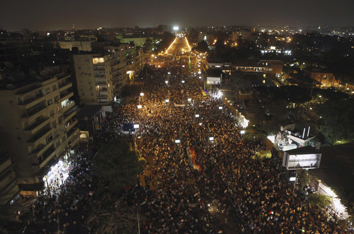 Protesters opposing
  Egyptian President Mohamed Morsi wave Egyptian flags and shout
  slogans against him and members of the Muslim Brotherhood, during
  a protest in front of El-Thadiya presidential palace in Cairo
  June 30, 2013. (Reuters)