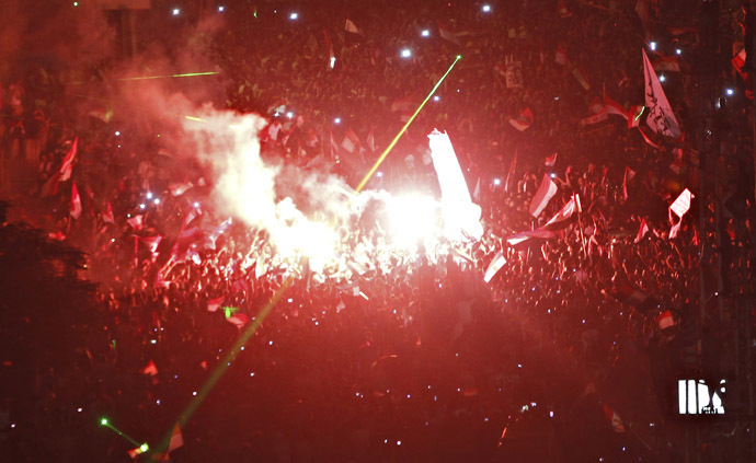 Protesters opposing Egyptian President Mohamed
  Mursi shout slogans and set off fireworks during a protest in
  front of El-Thadiya presidential palace in Cairo June 30, 2013.
  (Reuters)